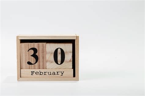 Premium Photo | Wooden calendar february 30 on a white background