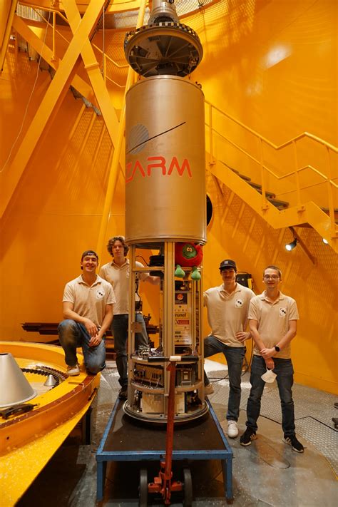 ESA - Students pose in front of their experiment in the deceleration chamber at the base of the ...