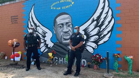 Houston police officers pay their respects to George Floyd at a mural in his hometown | CNN