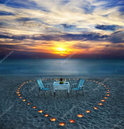 Romantic dinner on sea beach with candles Stock Photo by ©EM_prize 24547163