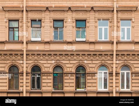 Several windows in a row on facade of urban apartment building front ...