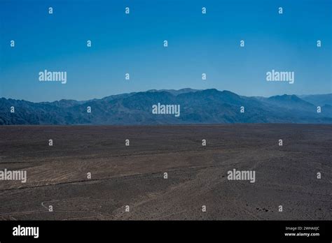 blue sky and brown desert in the rocky highlands near Nazca with desert ...