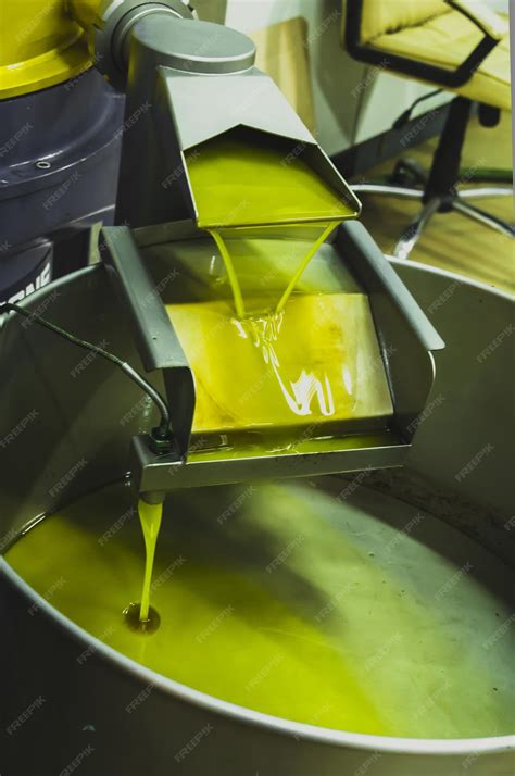 Premium Photo | Vertical shot of olive oil extraction process in a factory