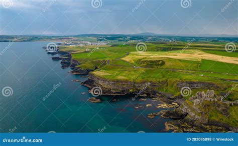 Aerial View of the Historic Dunluce Castle and the Green Fields ...