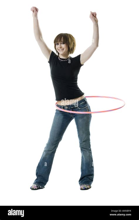 Portrait of a teenage girl spinning a hula hoop around her waist Stock Photo - Alamy