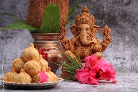 Ganesh Puja - Ganesh idol, hibiscus flower, durva, Sweet Modak food, mangal kalash Stock Photo ...
