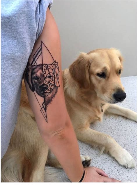 a person with a tattoo on their arm next to a dog