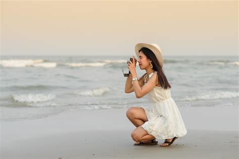 Premium Photo | Woman photographing at beach