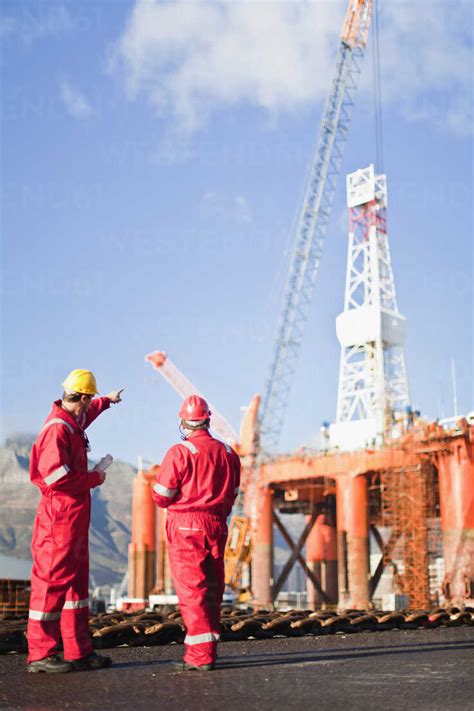 Workers talking on oil rig stock photo