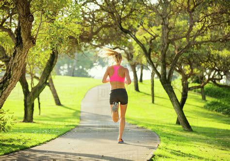Athletic Fit Young Woman Jogging Running Outdoors Early Morning In Park ...