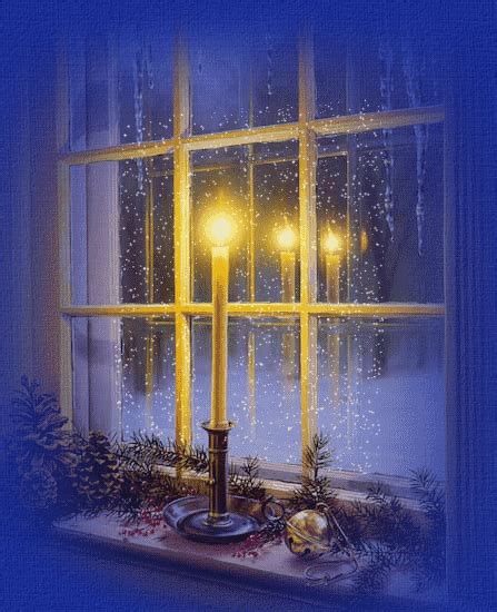 a lit candle sitting in front of a window with snow falling on the ...