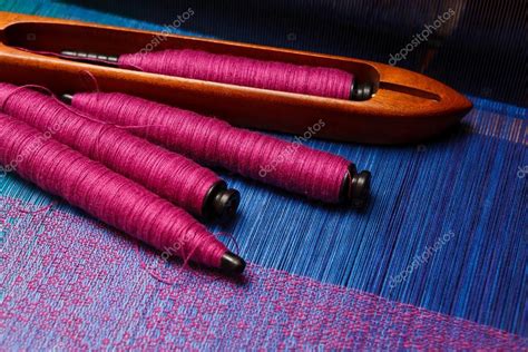 Weaving shuttle with spools of thread on the blue warp — Stock Photo ...