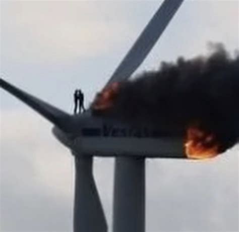 This picture tells the story of two engineers trapped on top of a wind turbine that’s on fire ...