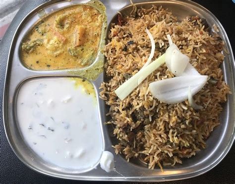 Bawarchi serves their biryani, korma, and raita in a traditional thali ...