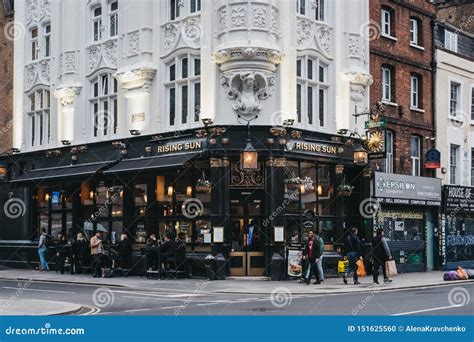 People Walking on a Street in Front of a Rising Sun Pub in London, UK Editorial Image - Image of ...