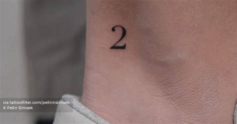 Little tattoo of the number "2" placed on the ankle.