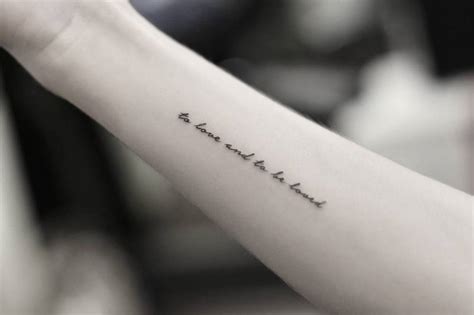 "To love and to be loved" tattoo on the forearm.