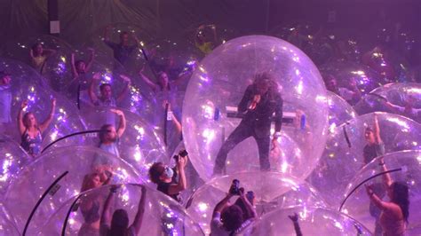 The Flaming Lips perform concert with band, fans encased in plastic ...