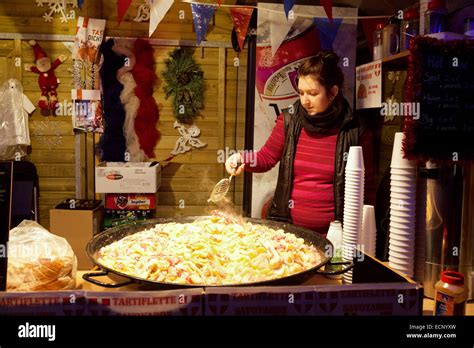 A market stallholder making tartiflette, Bruges Christmas Market Stock ...