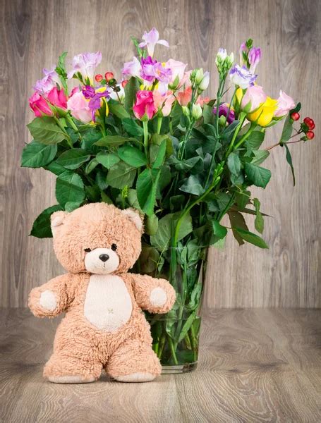 Teddy bear and flowers — Stock Photo © Tchumak #53676249