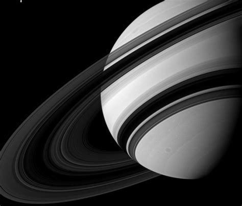 The moon Tethys is seen next to Saturn in this NASA handout image – Science World