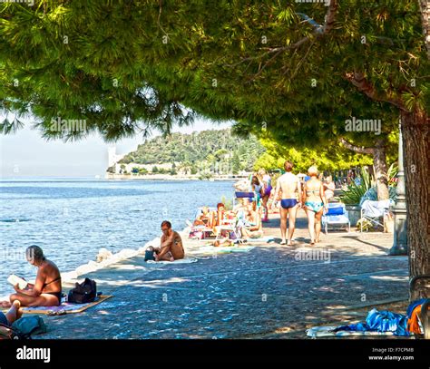 Trieste, Italy, beautiful summer view of Barcola promenade and free bathing strand with people ...