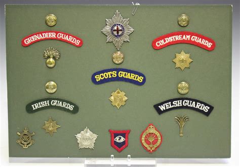 A collection of British cap badges, including Guards Machine Gun ...