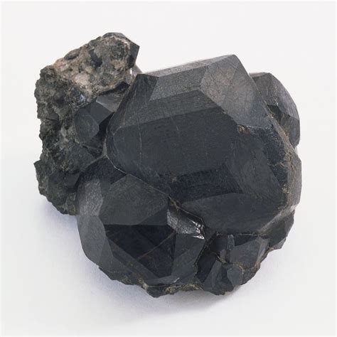 Black crystals occur in nature, such as this specimen of melanite ...