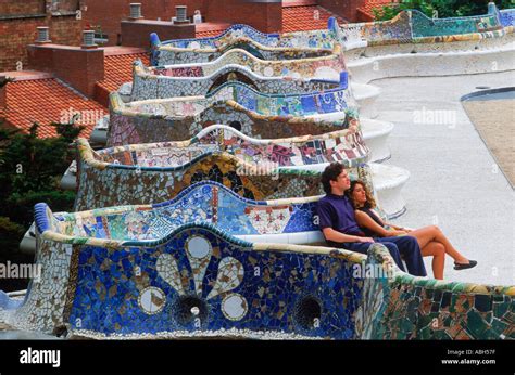 Couple on mosaic tile bench by Antonio Gaudi at Guell Park in Stock Photo: 2381182 - Alamy