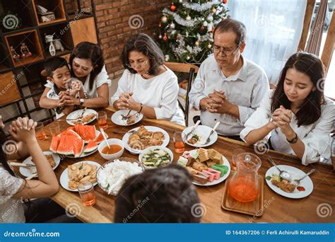 Christian Family Praying before Meals Stock Photo - Image of happiness ...