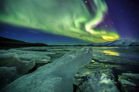 Auroral over the glacier lagoon Jokulsarlon in Iceland. - Encompass The World Travel