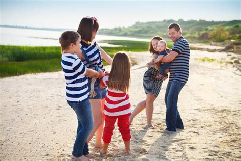 Tug of War - Family Playing on the Beach Stock Image - Image of girl, activity: 55349349