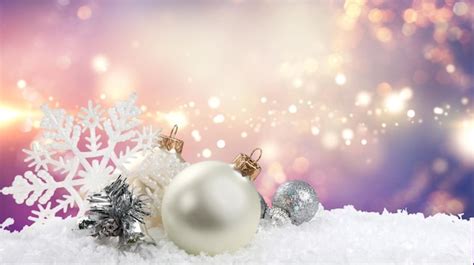 Premium Photo | Silver christmas balls over snow isolated on white