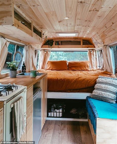 The interior of the bus is pictured, which shows the couple's kitchen ...