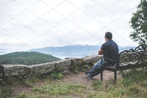 Man sitting on a bench alone, contem | People Images ~ Creative Market