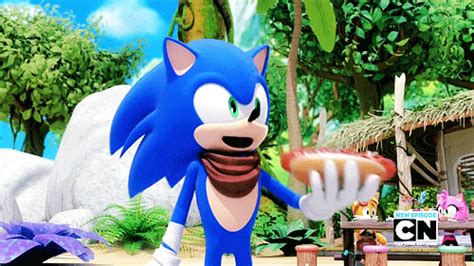 sonic the hedgehog is holding something in one hand and standing next to a picnic table