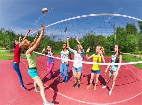 Teenagers playing volleyball — Stock Photo © serrnovik #77385680