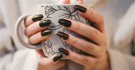 Woman With Black Manicure Holding White and Grey Floral Ceramic Cup · Free Stock Photo