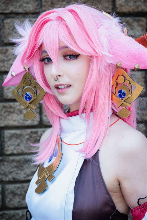 Female Cosplayer in a Pink Anime Costume Wearing Pink Hair Stock Photo - Image of raises ...