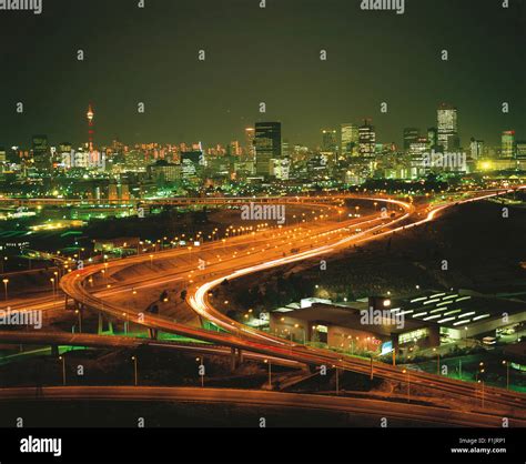 Johannesburg cityscape at night with highway and skyline in background ...