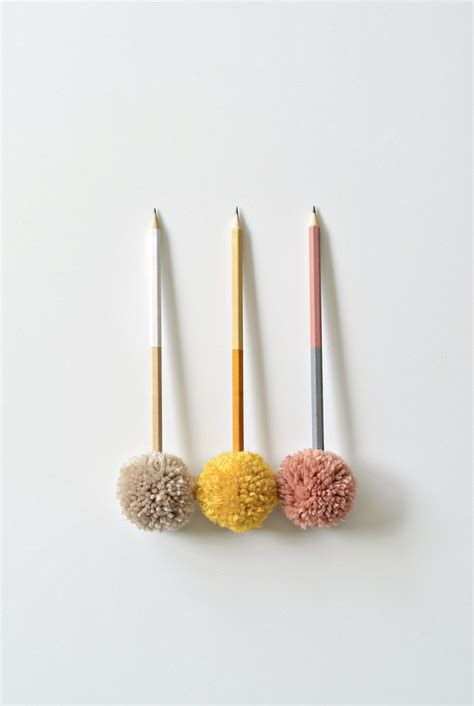 three different colored pencils sitting next to each other on top of a ...