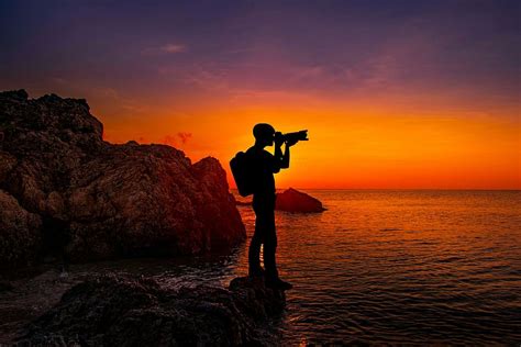 HD wallpaper: silhouette photo of a photographer standing on rack ...