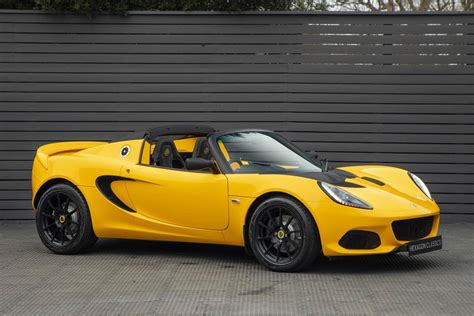 Download Stunning Yellow Lotus Sports Car in Garage Wallpaper | Wallpapers.com