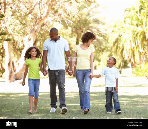 Portrait of Happy Family Walking In Park Stock Photo - Alamy