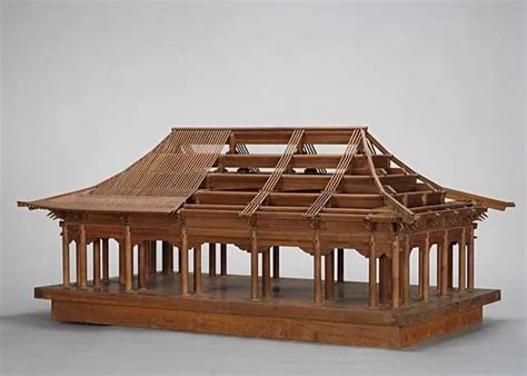 a wooden model of a building with two levels