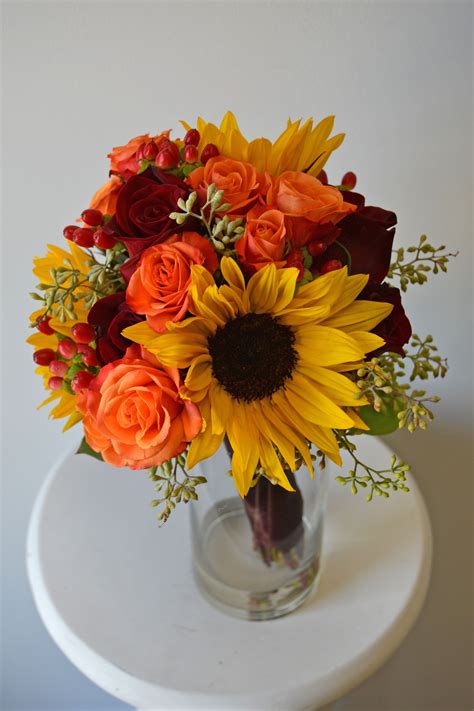 Fall bouquet with mini sunflowers, orange spray roses, black magic roses, red hypericum berries ...