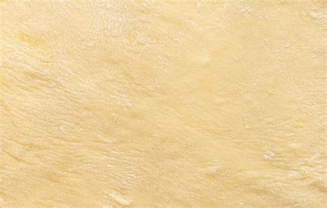 Premium Photo | Texture of evenly rolled doughBackground of the dough for baking