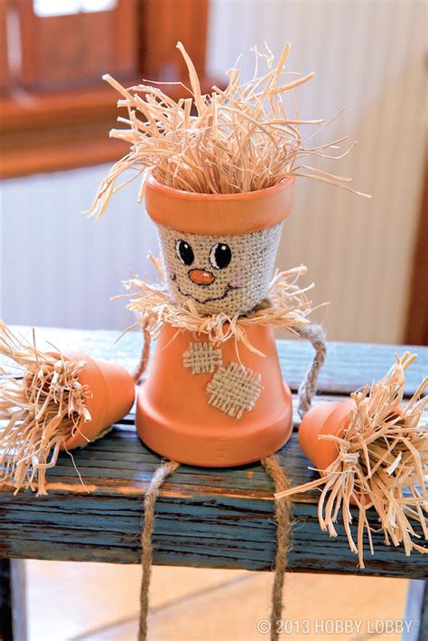 Create a friendly DIY fall project with terra-cotta pots, straw, and a ...