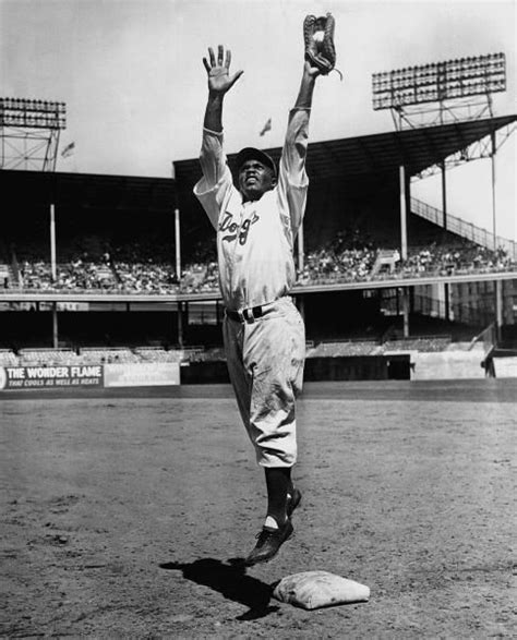 Brooklyn Dodgers second baseman Jackie Robinson fielding during a 1947 ...