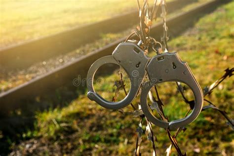 Handcuffs Hang on Barbed Wire. Prison. Law and Order Stock Image - Image of escape, wire: 261602231